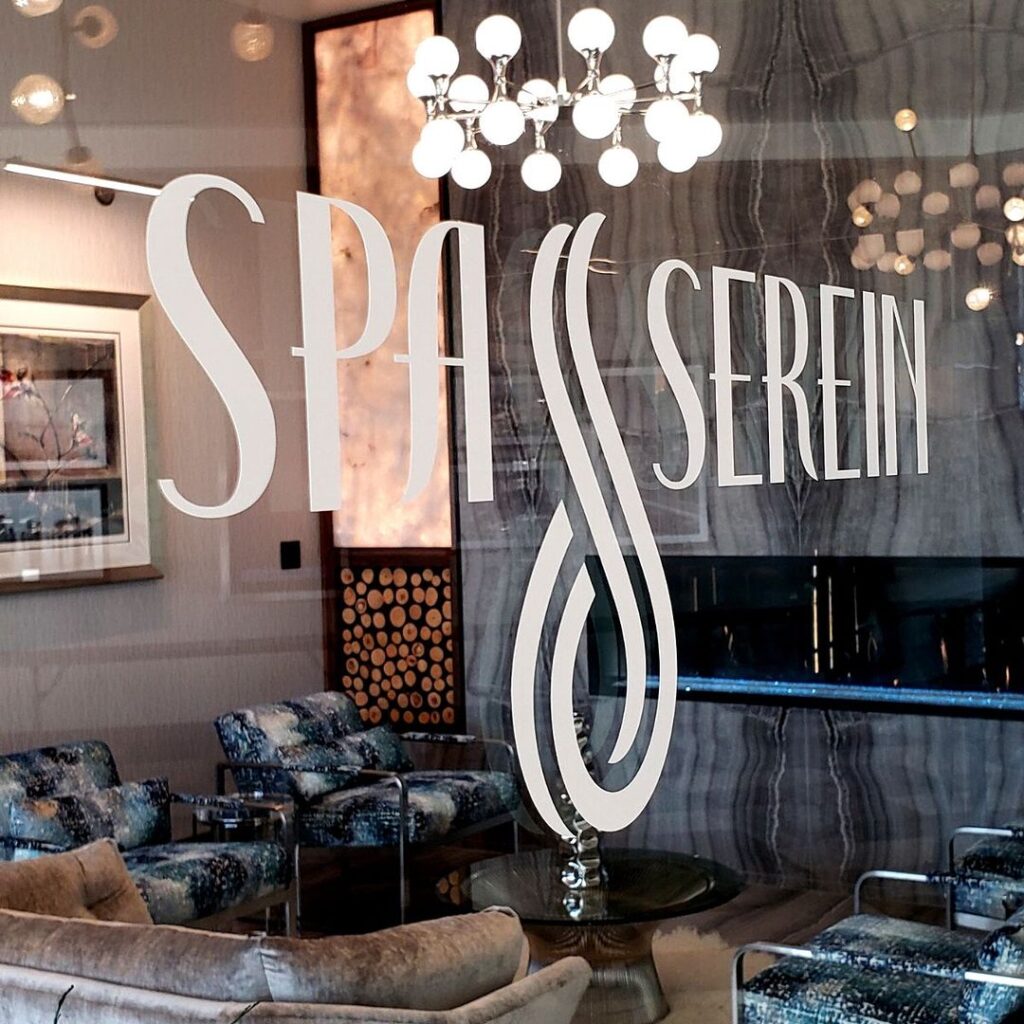 The Spa Serein logo on the glass of the storefront window for the spa.